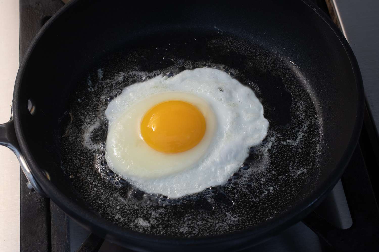 Egg with most of the white firm in the skillet