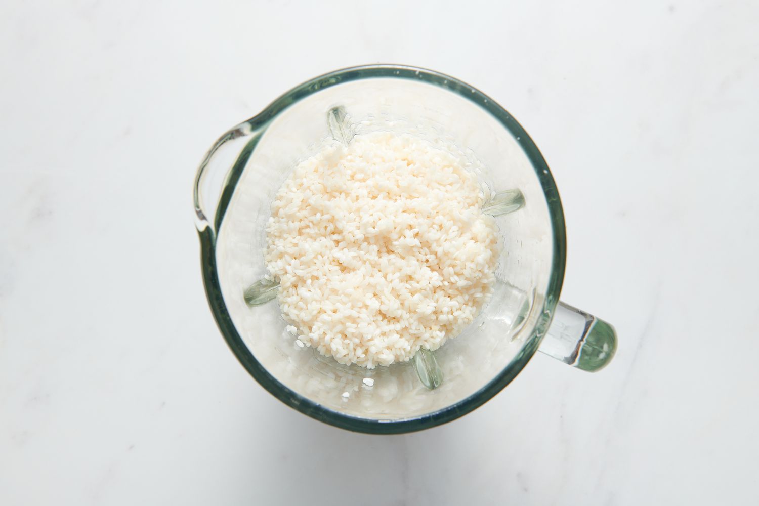 A blender pitcher with soaked Sona Masuri rice