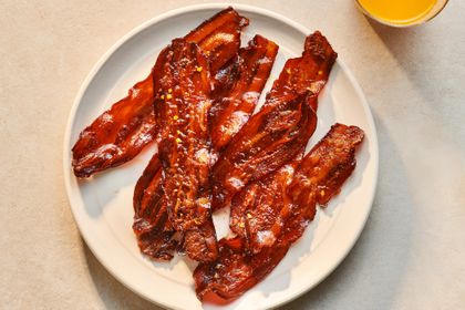 A plate of Millionaire's Bacon served with orange juice