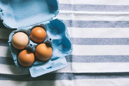 Brown eggs on striped tablecloth
