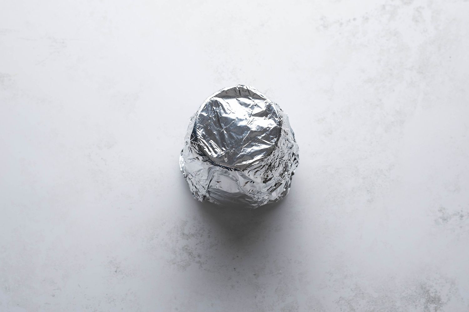 Lemon mixture in a glass container, covered with aluminum foil