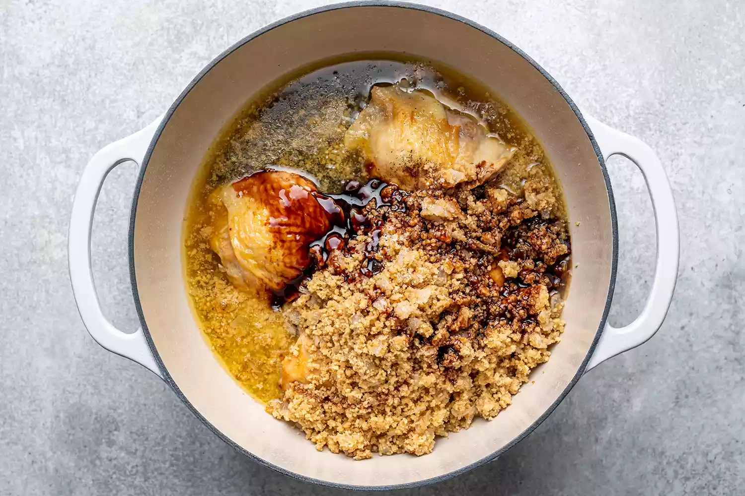 Uma panela com coxas de frango, nozes moídas, cebola, melado de romã, sal e pimenta