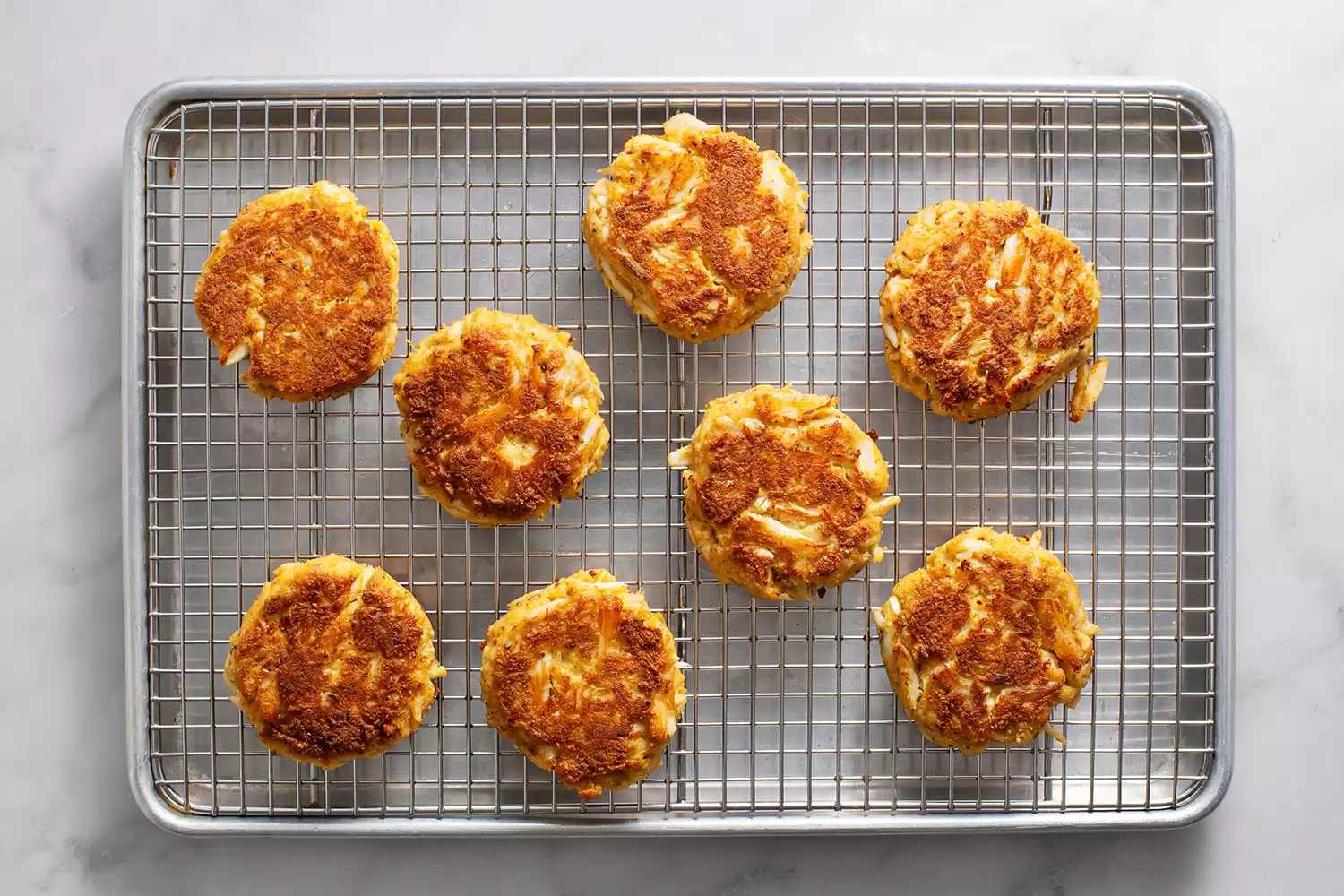 Bolinhos de caranguejo em uma grade de resfriamento