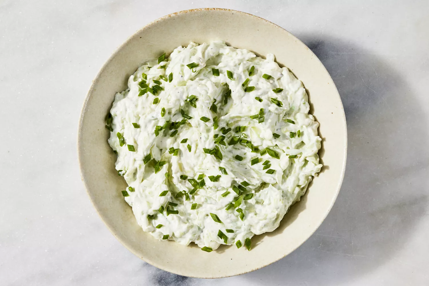 Benedictine Spread in ceramic bowl and topped with cut chives