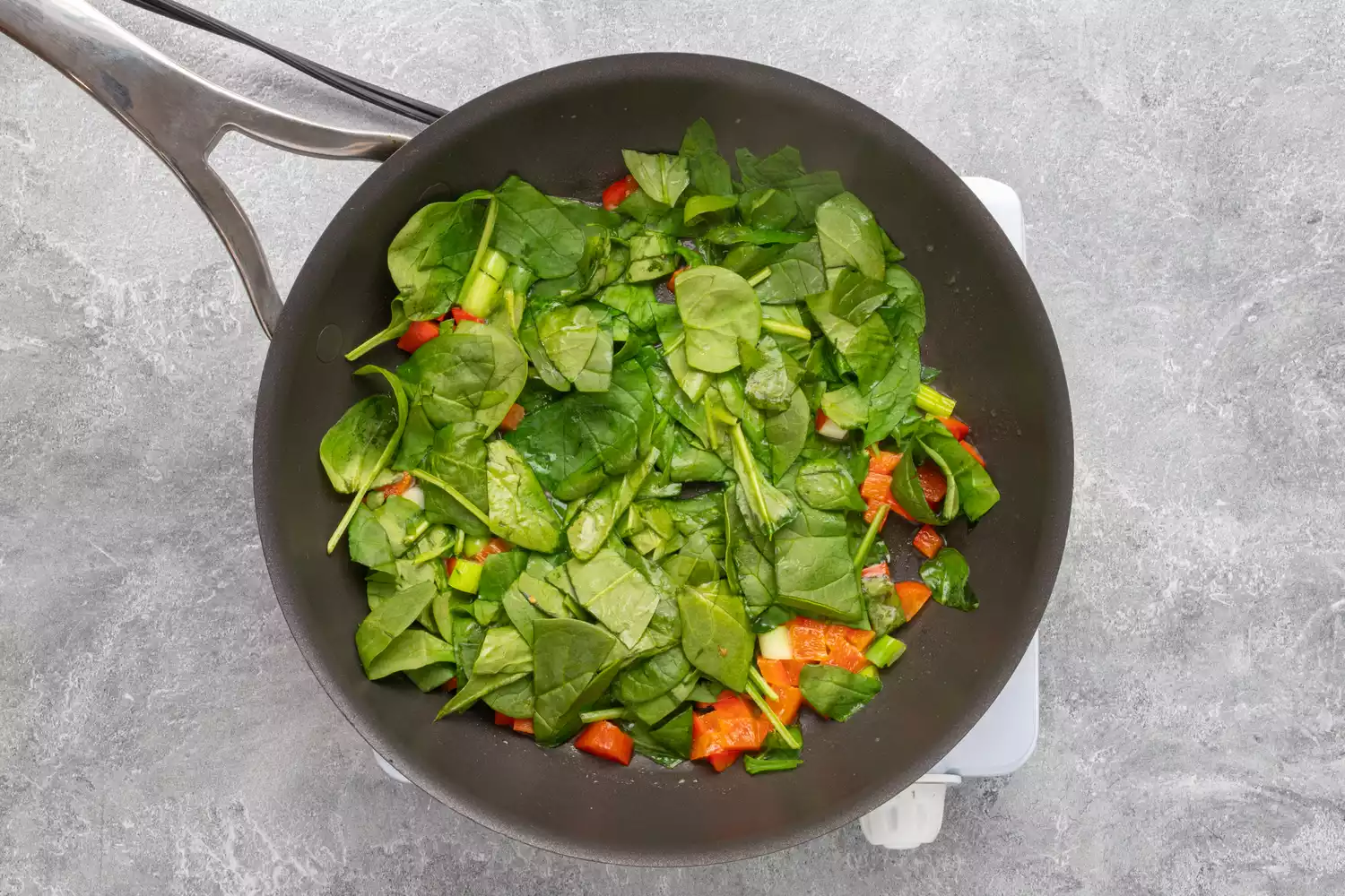 preparação da frittata de clara de ovo: espinafre na frigideira