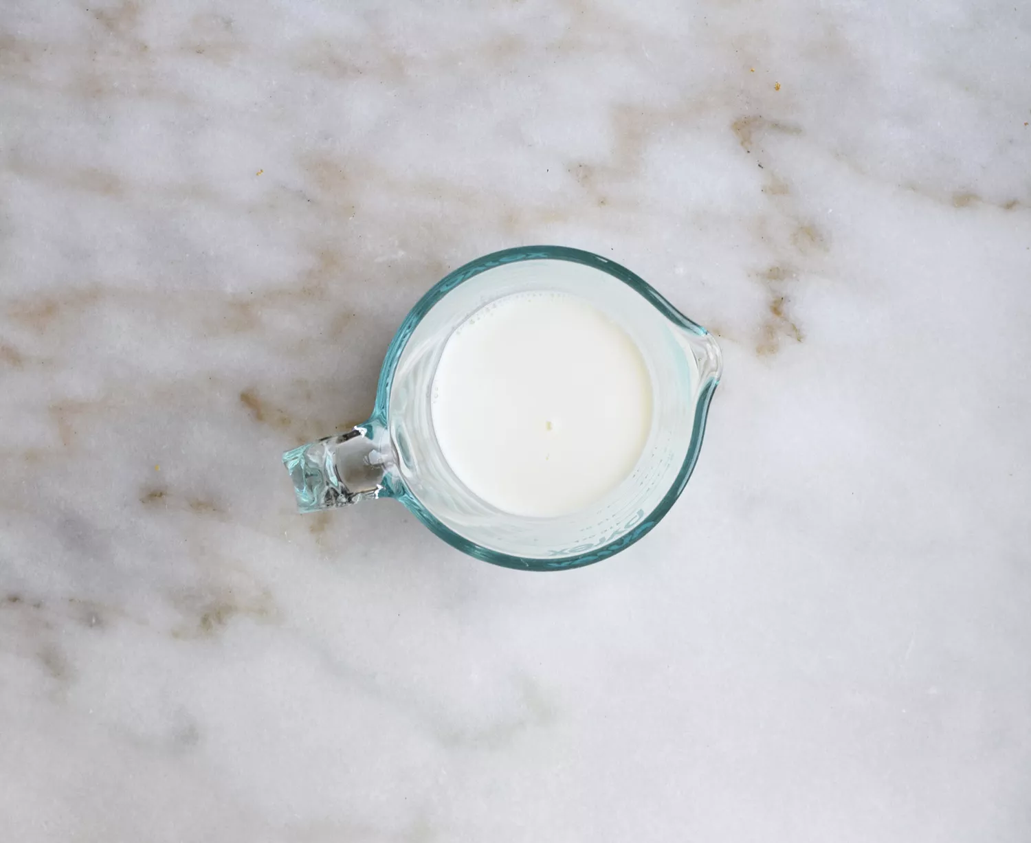 Leite e xarope de baunilha misturados em uma xícara de medição