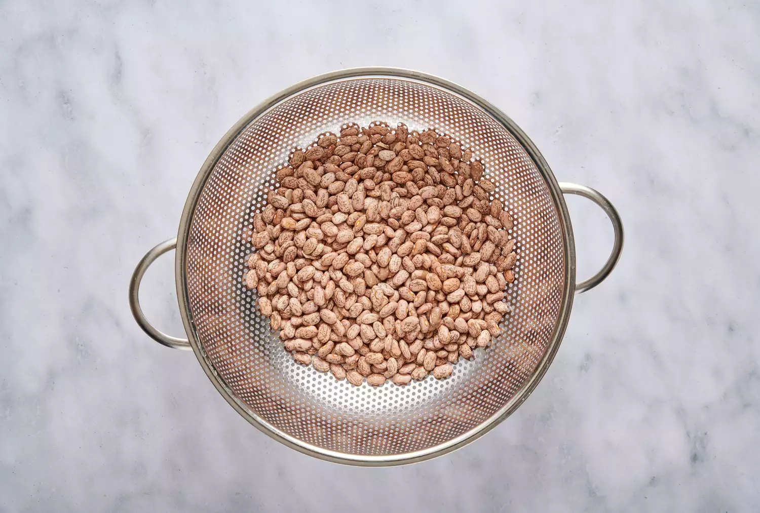 Um escorredor com feijões pinto